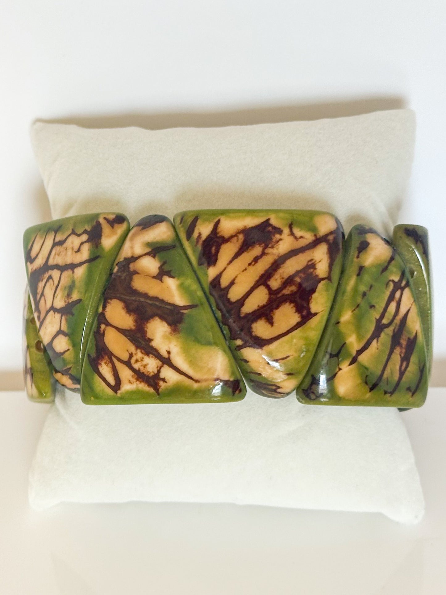 Green dyed jarina seed stretch bracelet made from vegetable ivory.