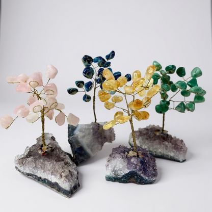 Handcrafted gemstone bonsai tree mounted on natural amethyst crystal base with wired branches and polished gemstone chips.