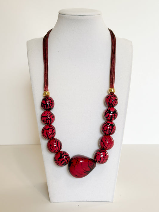 Handmade Amazon necklace made with jarina vegetable ivory and paxiúba seeds with cotton cord and metal accents.