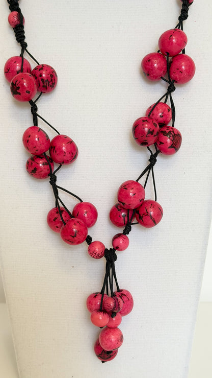 Handmade Brazilian necklace with pink Açaí seeds and dark cord