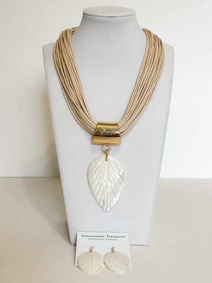 Handmade mother of pearl leaf necklace and earrings set crafted by an Amazon artisan.