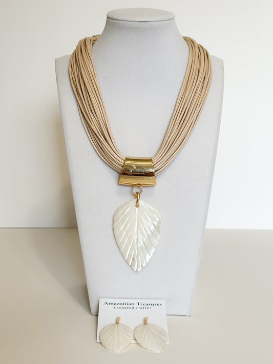 Handmade mother of pearl leaf necklace and earrings set crafted by an Amazon artisan.