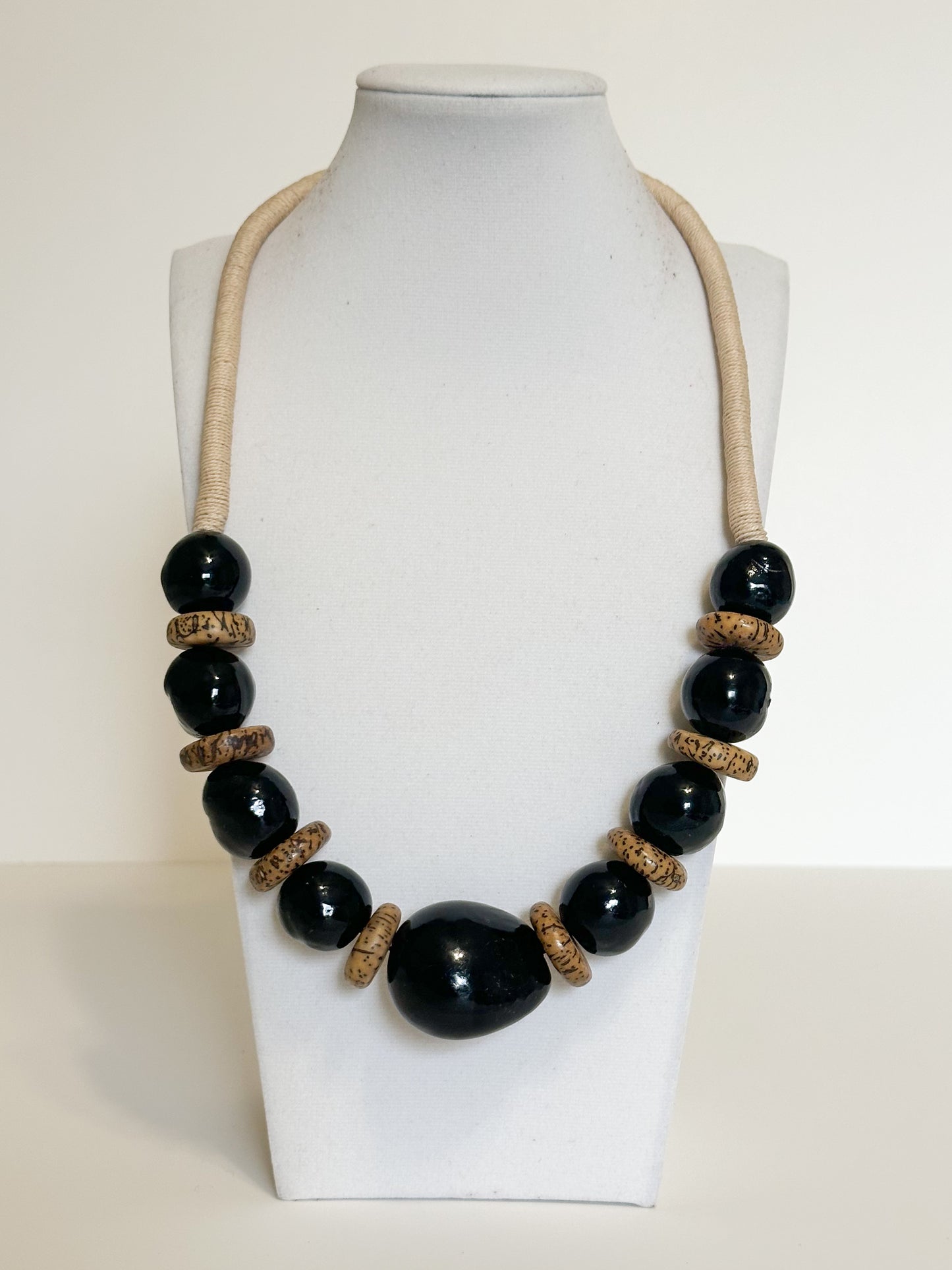Handmade necklace crafted with jarina (tagua), paxiúba and jupati seeds by Brazilian artisans.