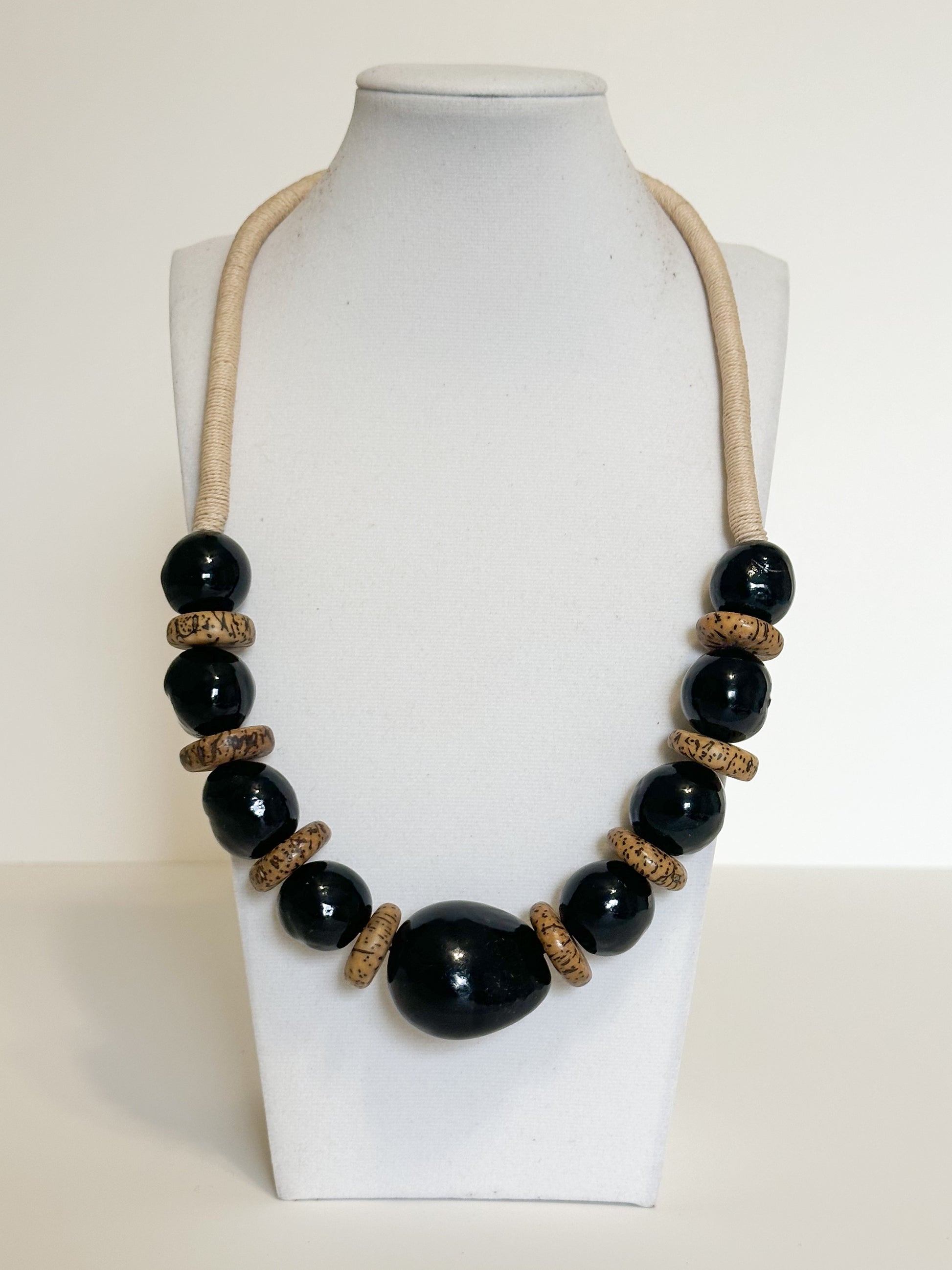 Handmade necklace crafted with jarina (tagua), paxiúba and jupati seeds by Brazilian artisans.