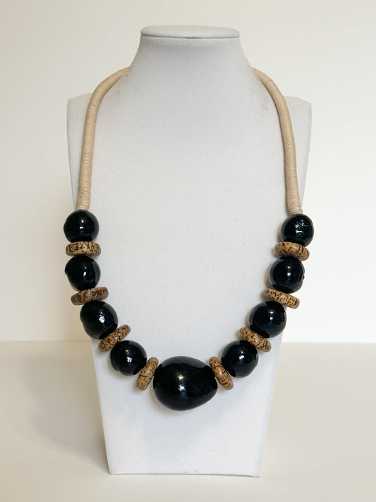 Handmade necklace crafted with jarina (tagua), paxiúba and jupati seeds by Brazilian artisans.