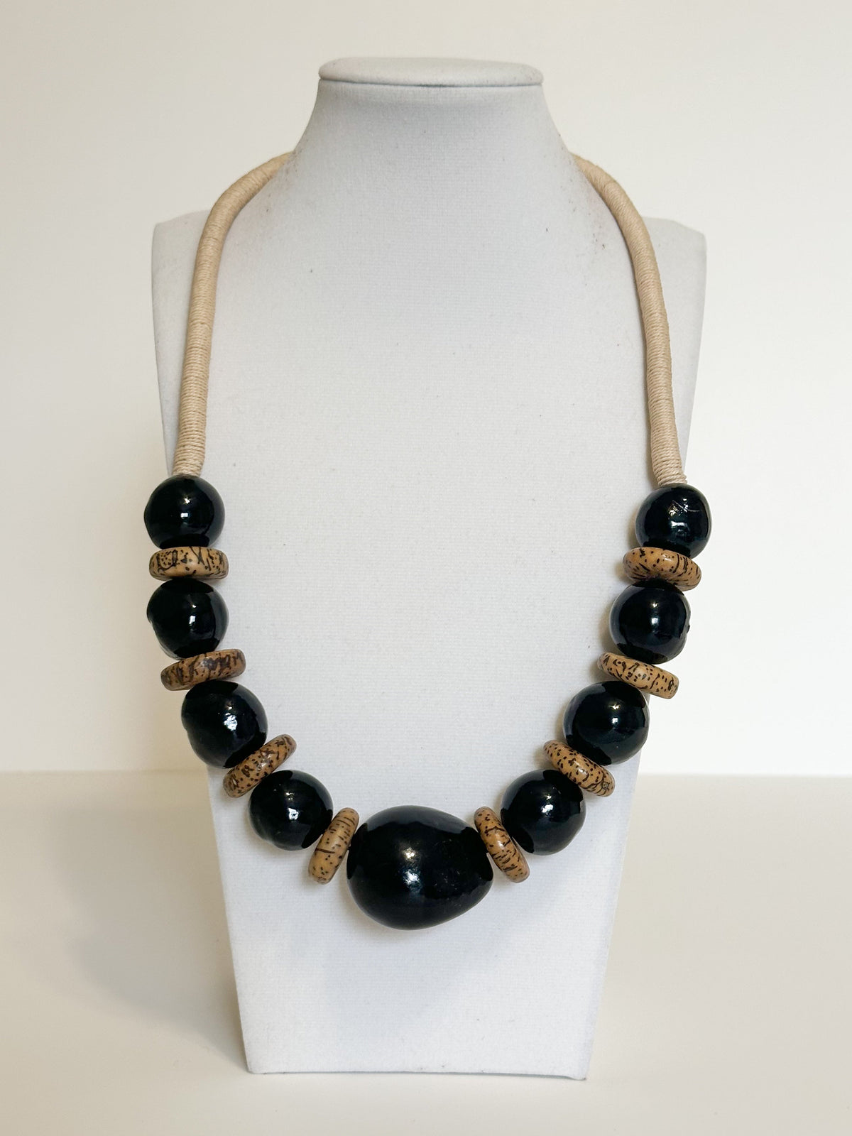Handmade necklace crafted with jarina (tagua), paxiúba and jupati seeds by Brazilian artisans.