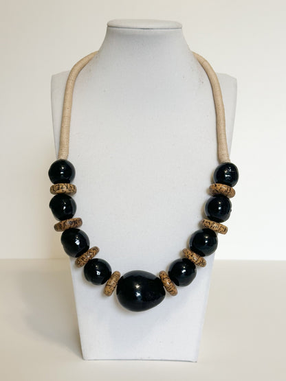 Handmade necklace crafted with jarina (tagua), paxiúba and jupati seeds by Brazilian artisans.