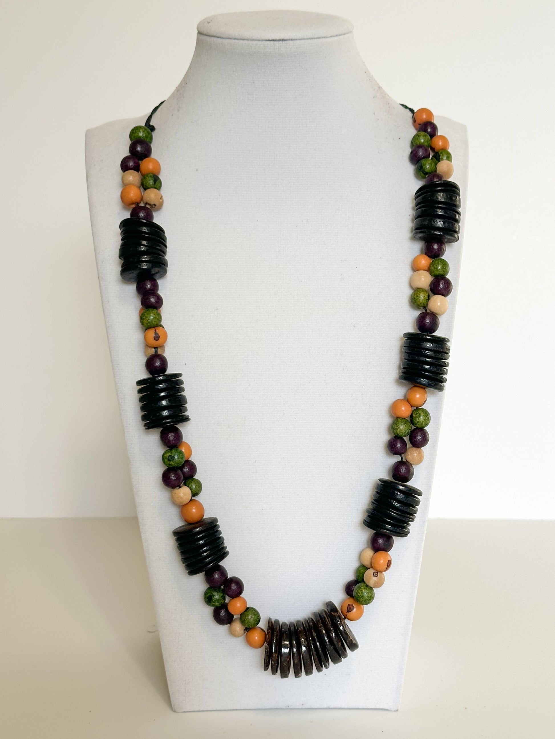 Handmade necklace crafted with natural açaí seeds and coconut shell beads from Brazil.