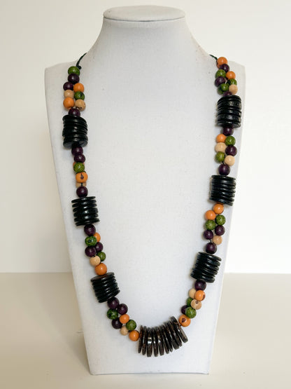 Handmade necklace crafted with natural açaí seeds and coconut shell beads from Brazil.