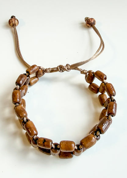 Handwoven brown Açaí seed bracelet made by a Brazilian artisan association