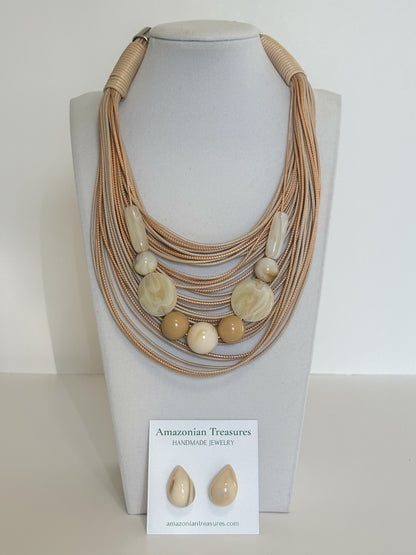 Layered cotton cord necklace with resin beads and matching resin earrings designed by a Brazilian jewelry studio.