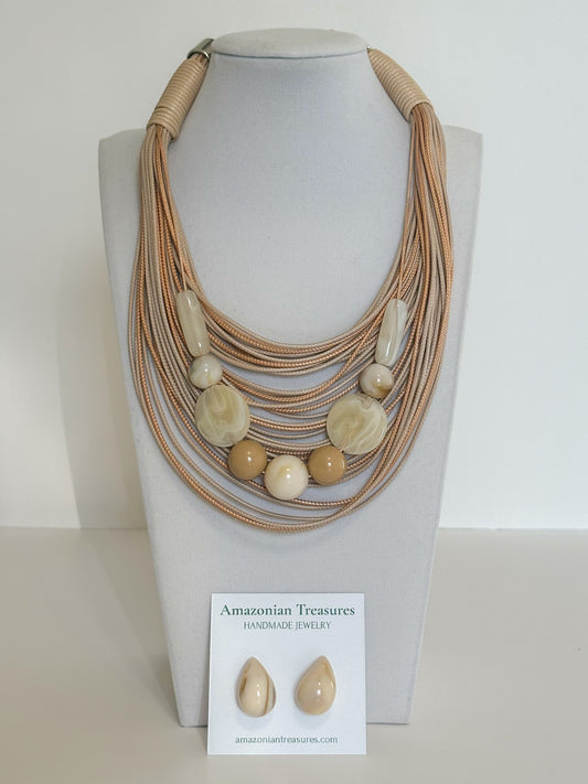 Layered cotton cord necklace with resin beads and matching resin earrings designed by a Brazilian jewelry studio.