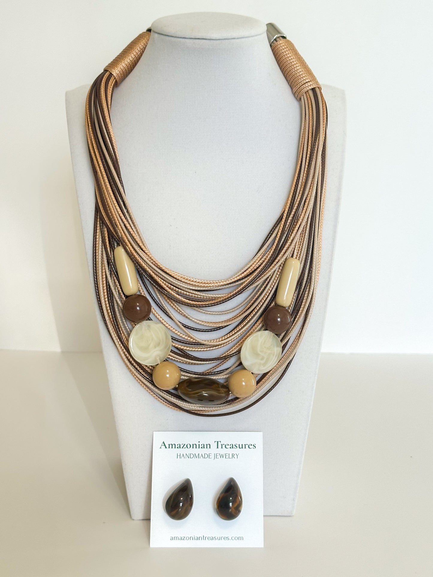 Layered cotton cord necklace with resin beads and matching resin earrings designed by a Brazilian jewelry studio. Brown