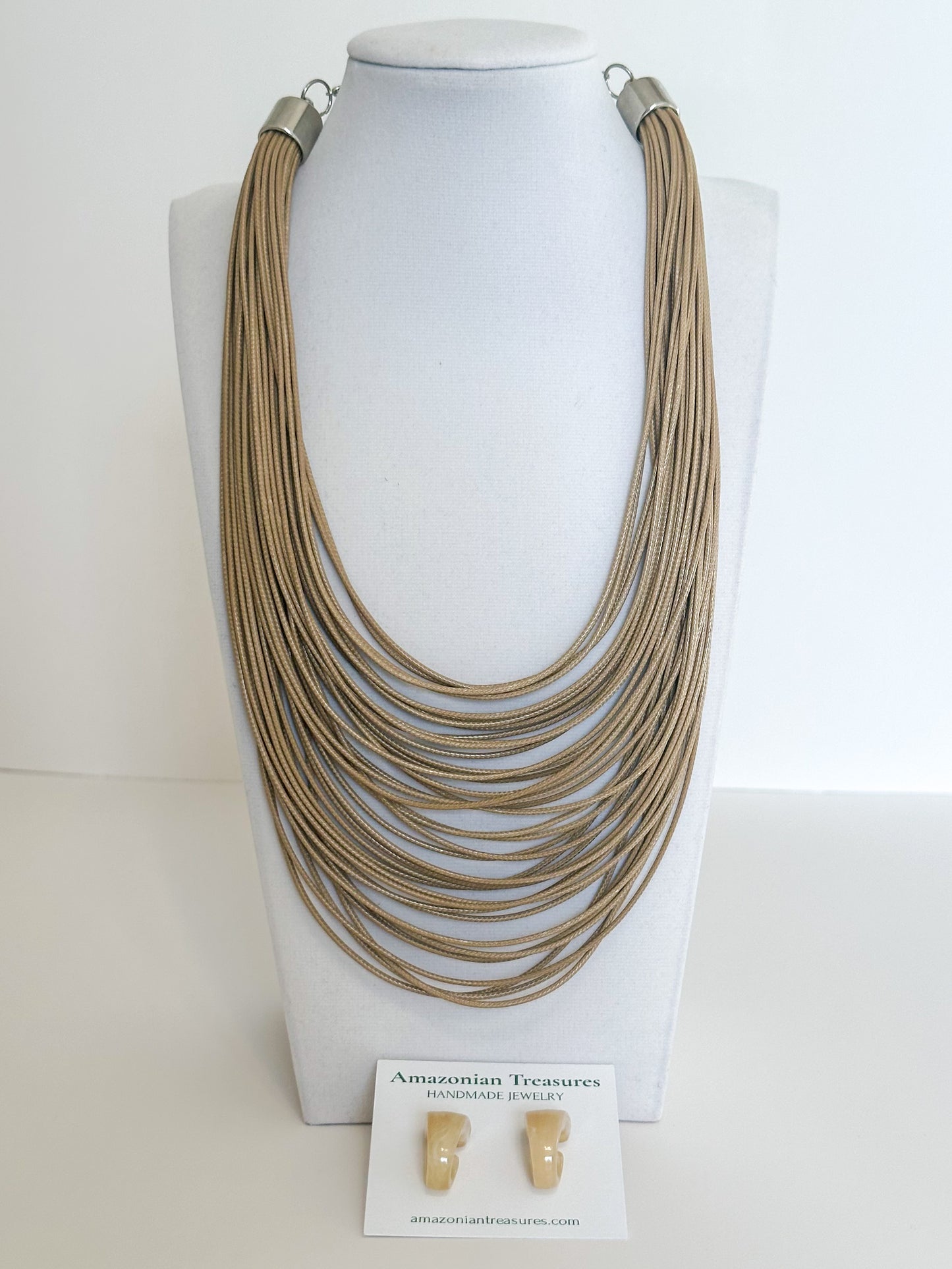 Layered cotton cord necklace with resin earrings designed by a Brazilian jewelry studio. Beige