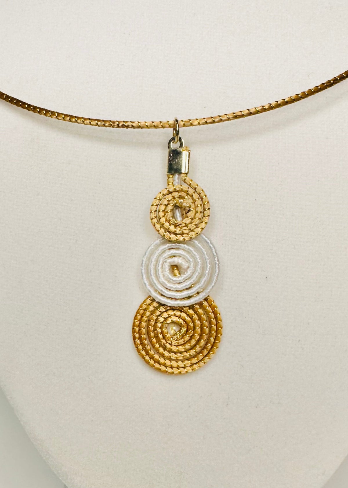 Layered golden grass pendant with white tinted detail