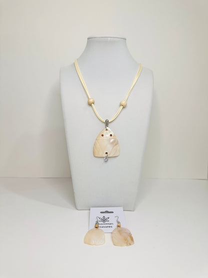 Mother of pearl Muiraquitã necklace and earring set displayed on white bust
