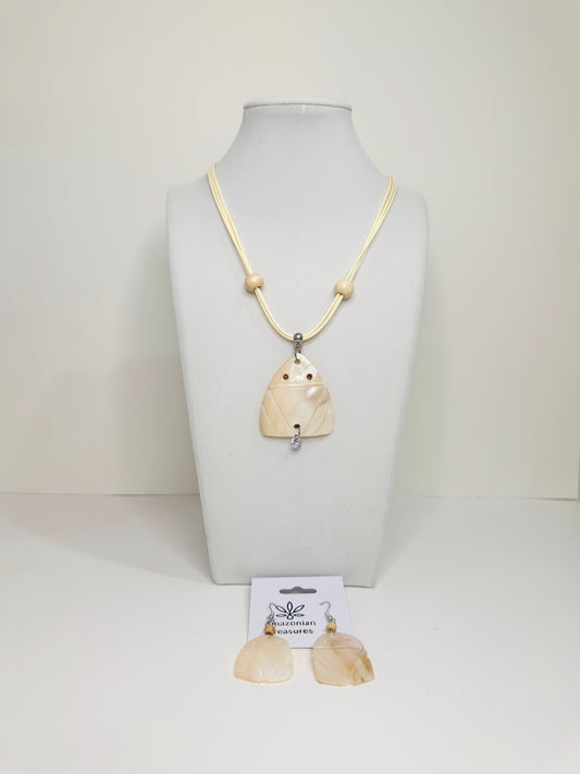 Mother of pearl Muiraquitã necklace and earring set displayed on white bust