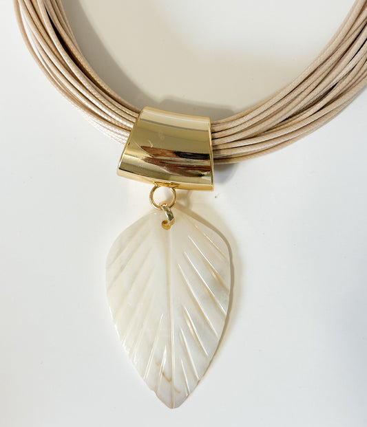 Mother of pearl leaf pendant carved from freshwater shell from the Amazon rivers close-up