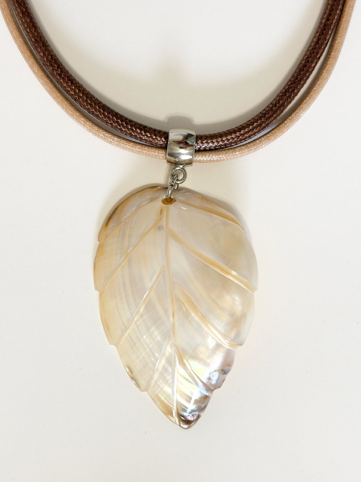 Mother of pearl shell leaf pendant carved from Amazon river shell. Light white