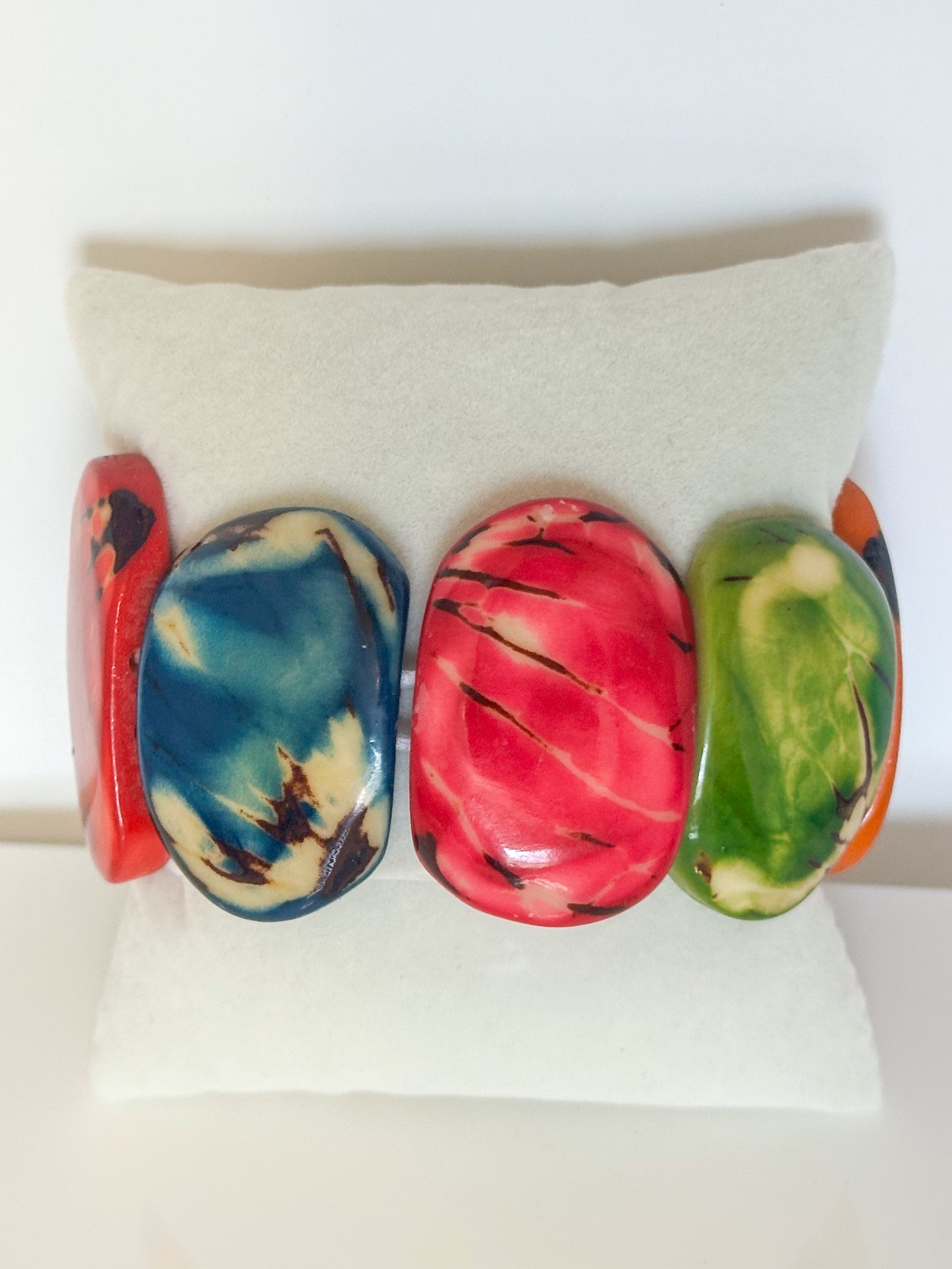 Multicolor dyed jarina seed stretch bracelet with natural patterns.