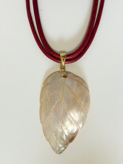 Natural mother of pearl leaf necklace with layered cord.