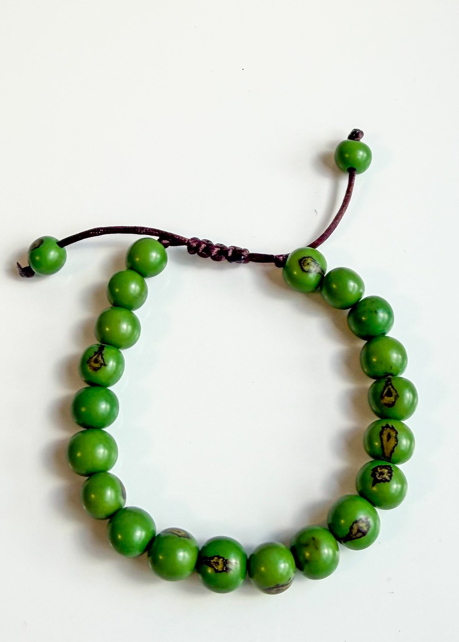 Nature-crafted Amazon seed bracelet green detail