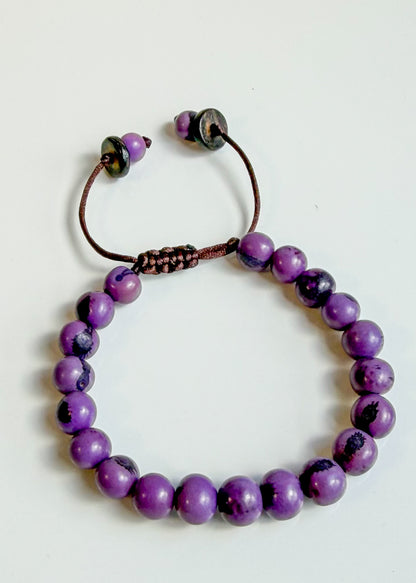 Nature-crafted Amazon seed bracelet purple detail