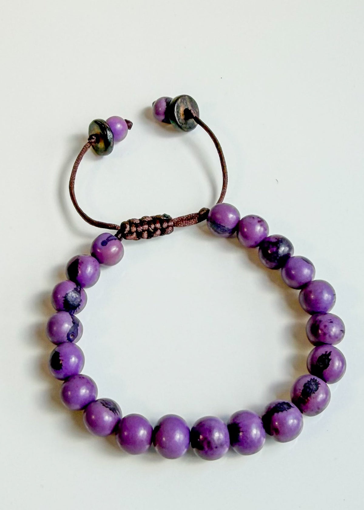 Nature-crafted Amazon seed bracelet purple detail