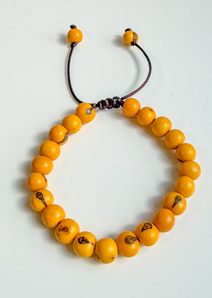 Nature-crafted Amazon seed bracelet yellow detail