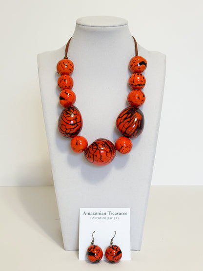 Orange dyed jarina bead necklace and earrings made by Brazilian artisan.