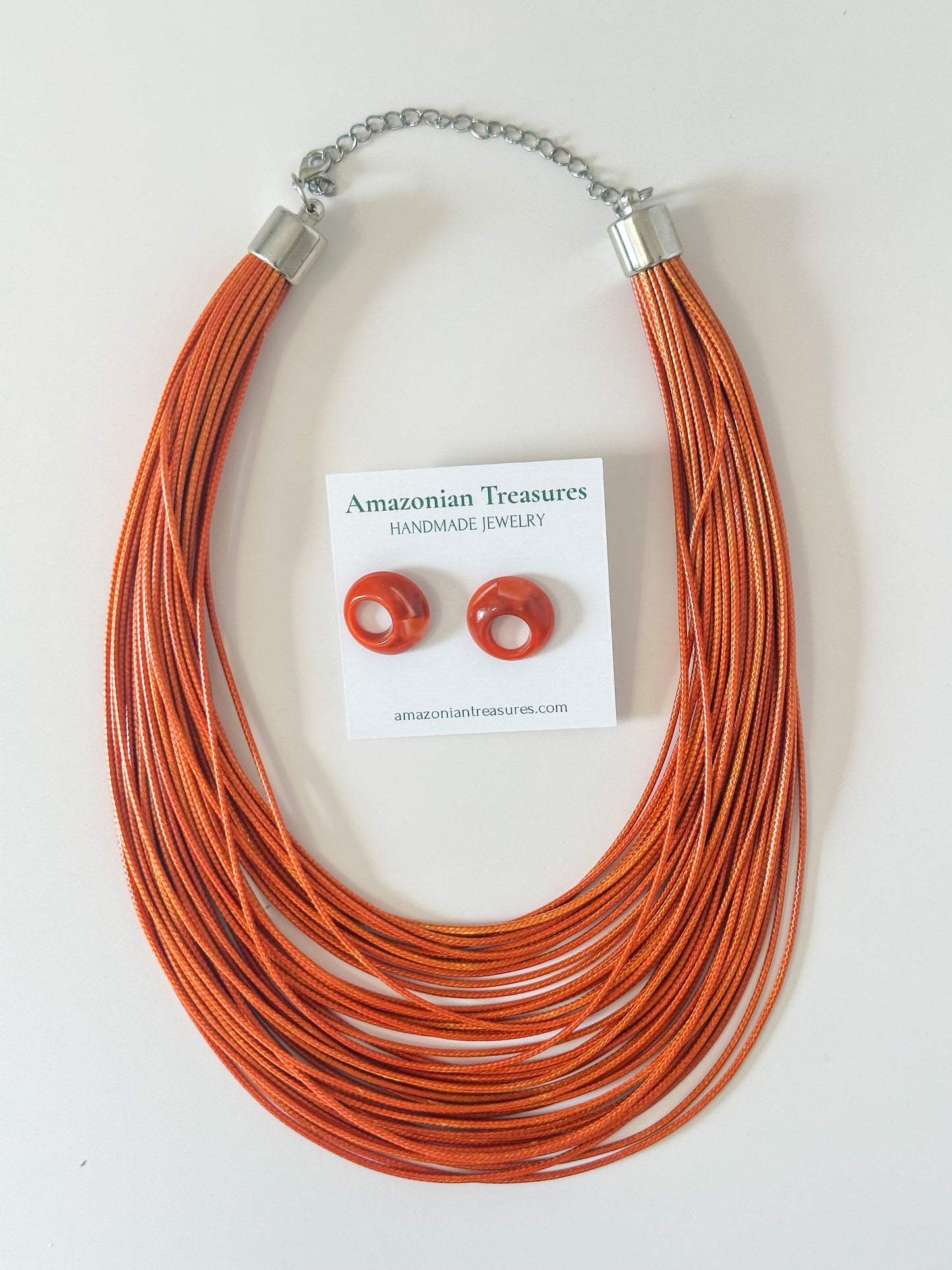 Orange layered cotton necklace with resin earrings.
