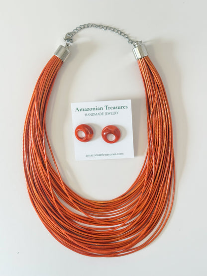 Orange layered cotton necklace with resin earrings.