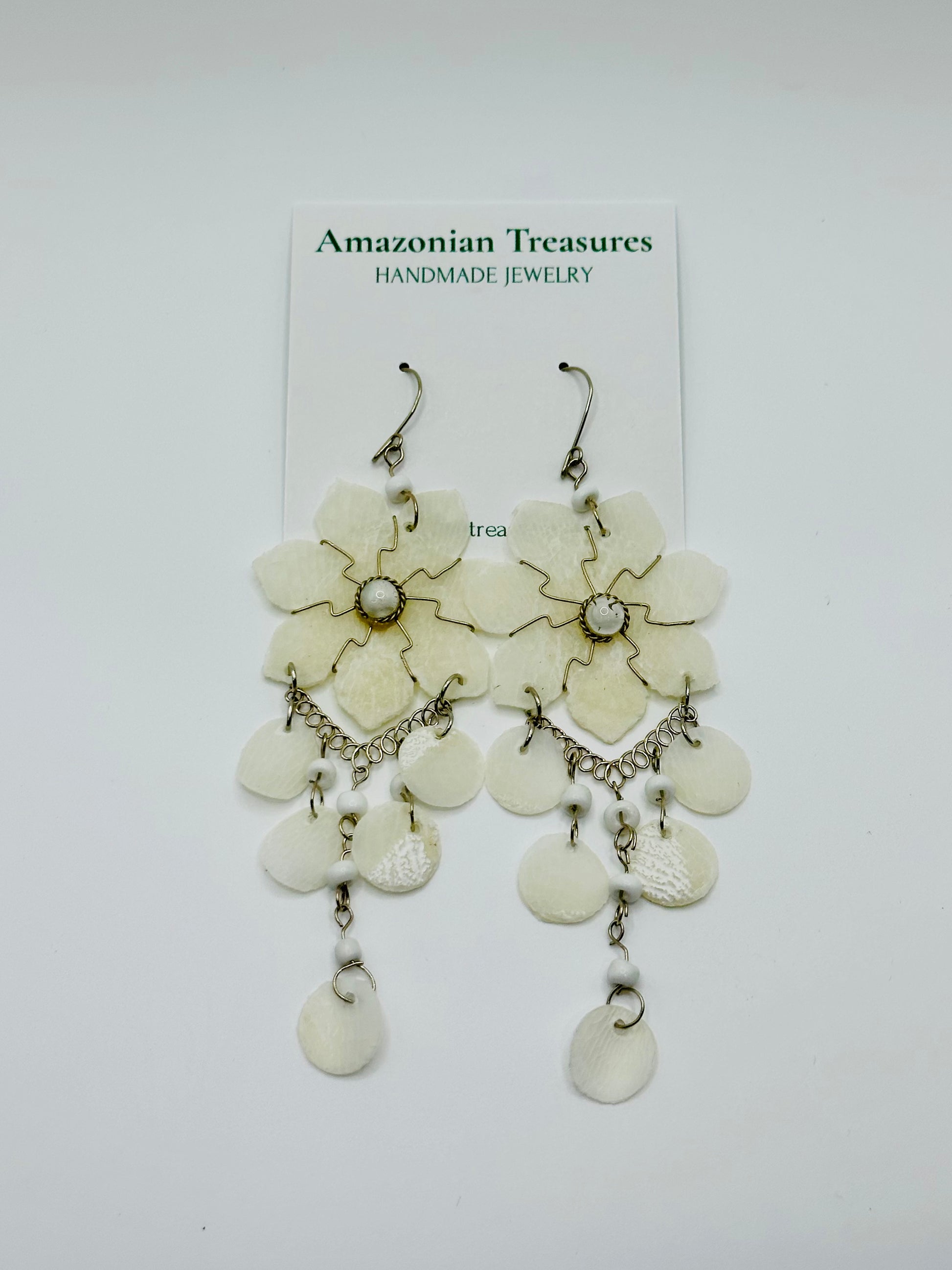 Pirarucu fish scale earrings handcrafted by riverside artisans in the Brazilian Amazon