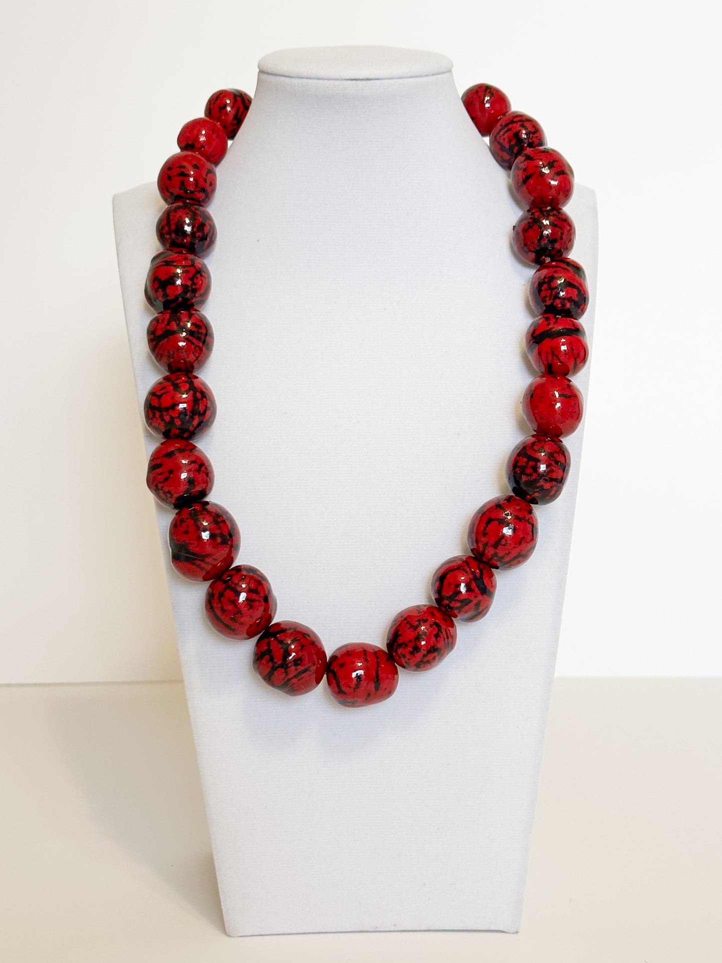 Red tinted paxiúba seed necklace crafted by Rio Negro artisans.
