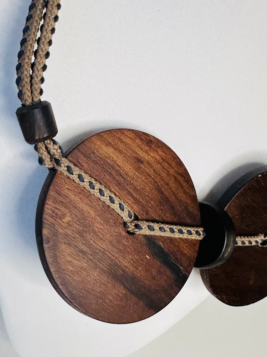 Round wood pendant detail on artisan necklace