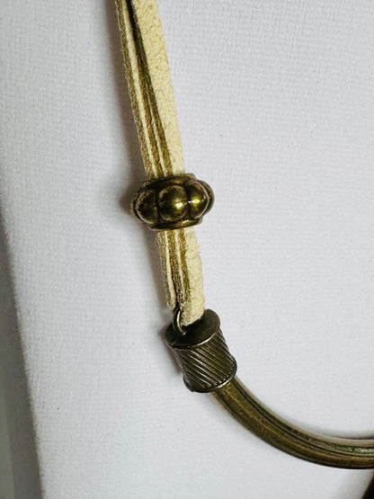 Turquoise Tooth statement necklace featuring sculptural wood pendant with turquoise accent on structured cord. detail