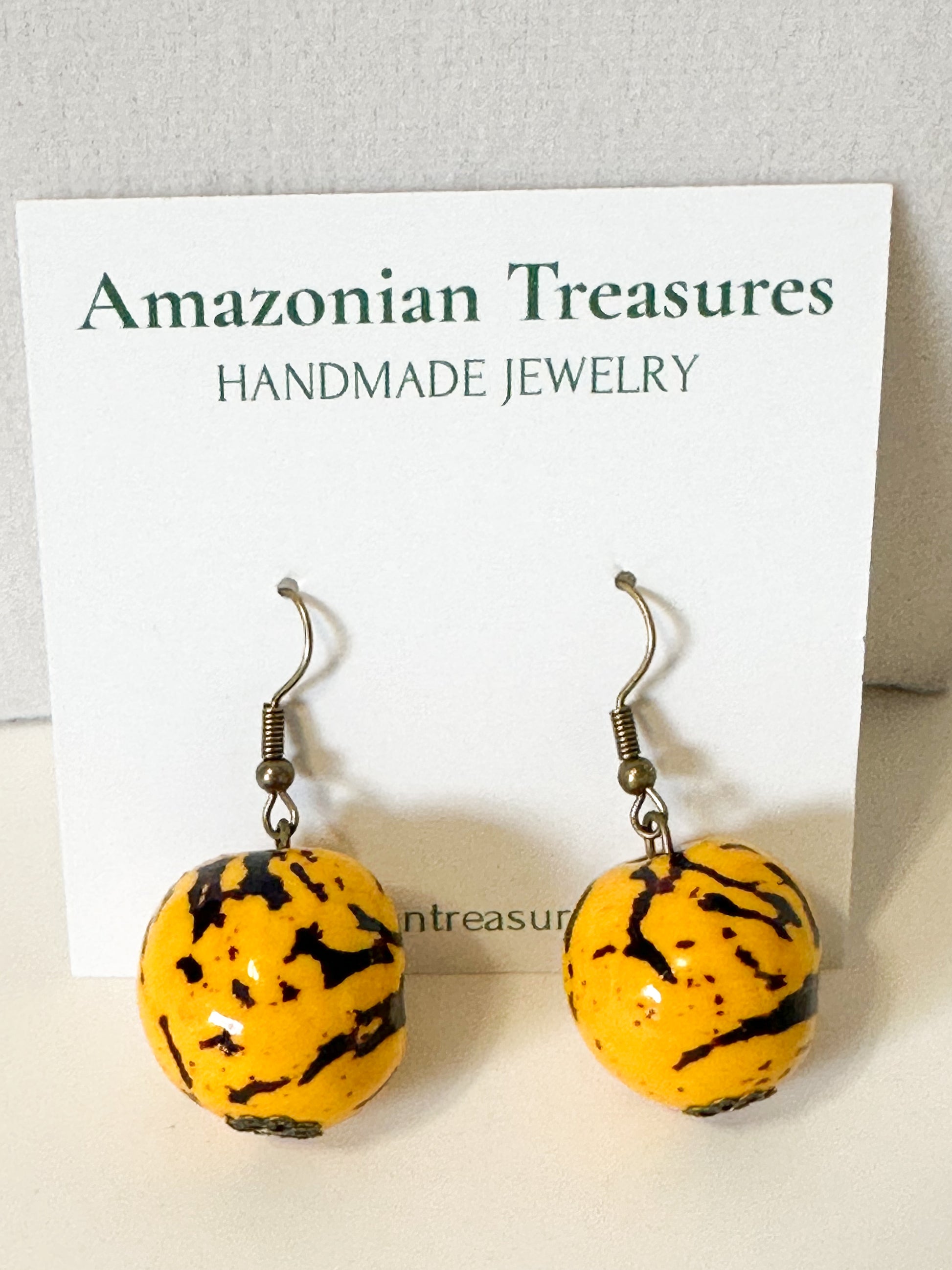 Yellow dyed jarina seed earrings from the Amazon Bloom set.