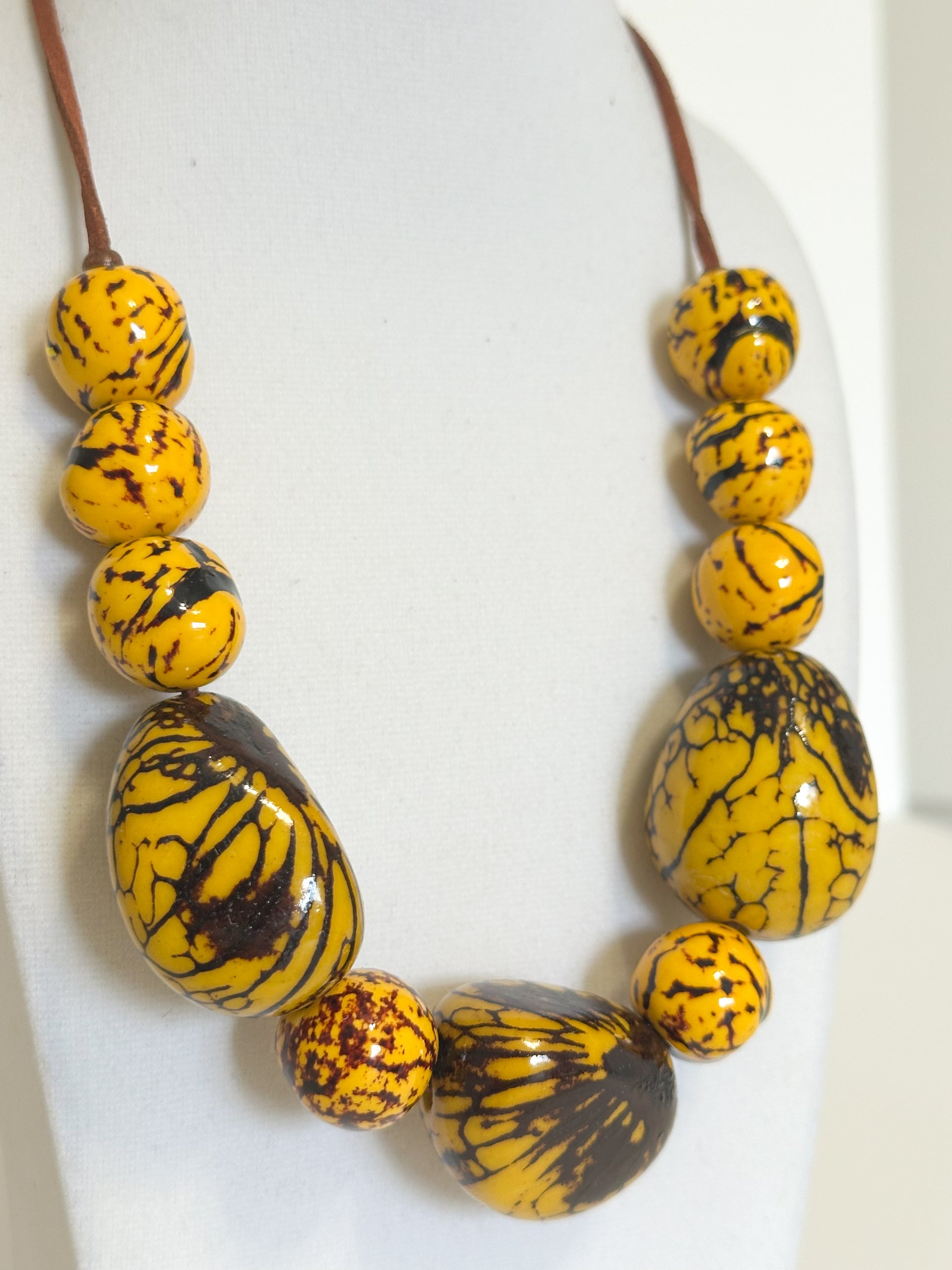 Yellow dyed jarina seed necklace and earrings from the Amazon Bloom set.
