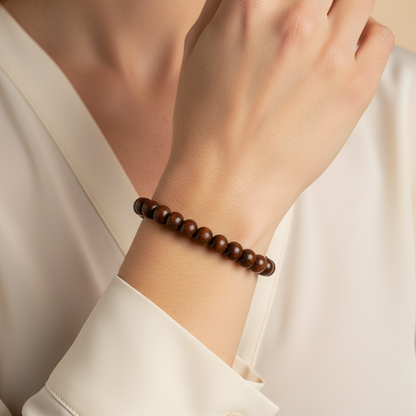 Amazonian Treasures handcrafted stretch bracelet made from polished brown açaí seeds worn on a woman's wrist
