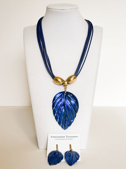Amazonian Treasures blue mother of pearl leaf necklace and earring set with gold-tone accents on a display bust