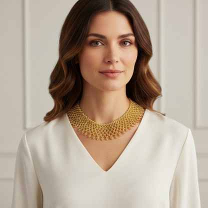 Amazonian Treasures Borari Indigenous gold glass beaded collar necklace with delicate fringe worn by a woman.