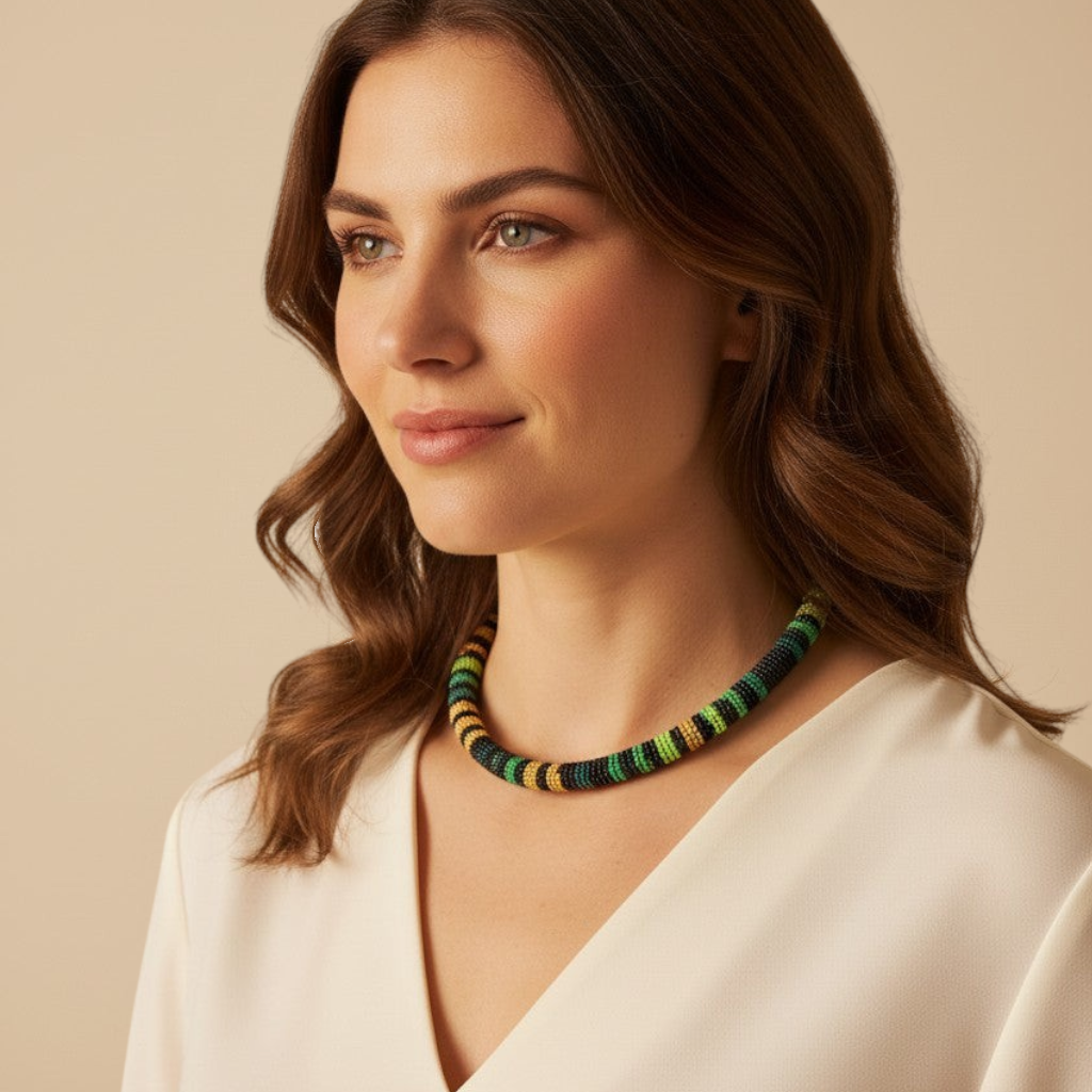Amazonian Treasures Borari Horizon necklace featuring black, green, and beige glass beads worn by a woman.