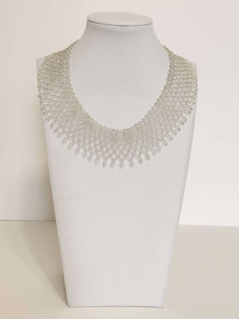 Amazonian Treasures Borari handcrafted silver glass bead collar necklace with intricate net-like fringe design.