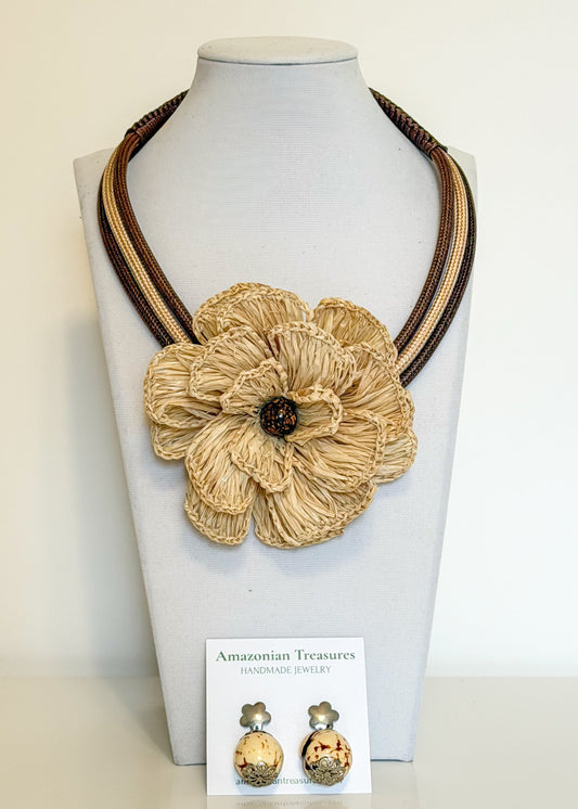 Amazonian Treasures handcrafted Buriti fiber flower statement necklace with matching Paxiúba seed earrings on display