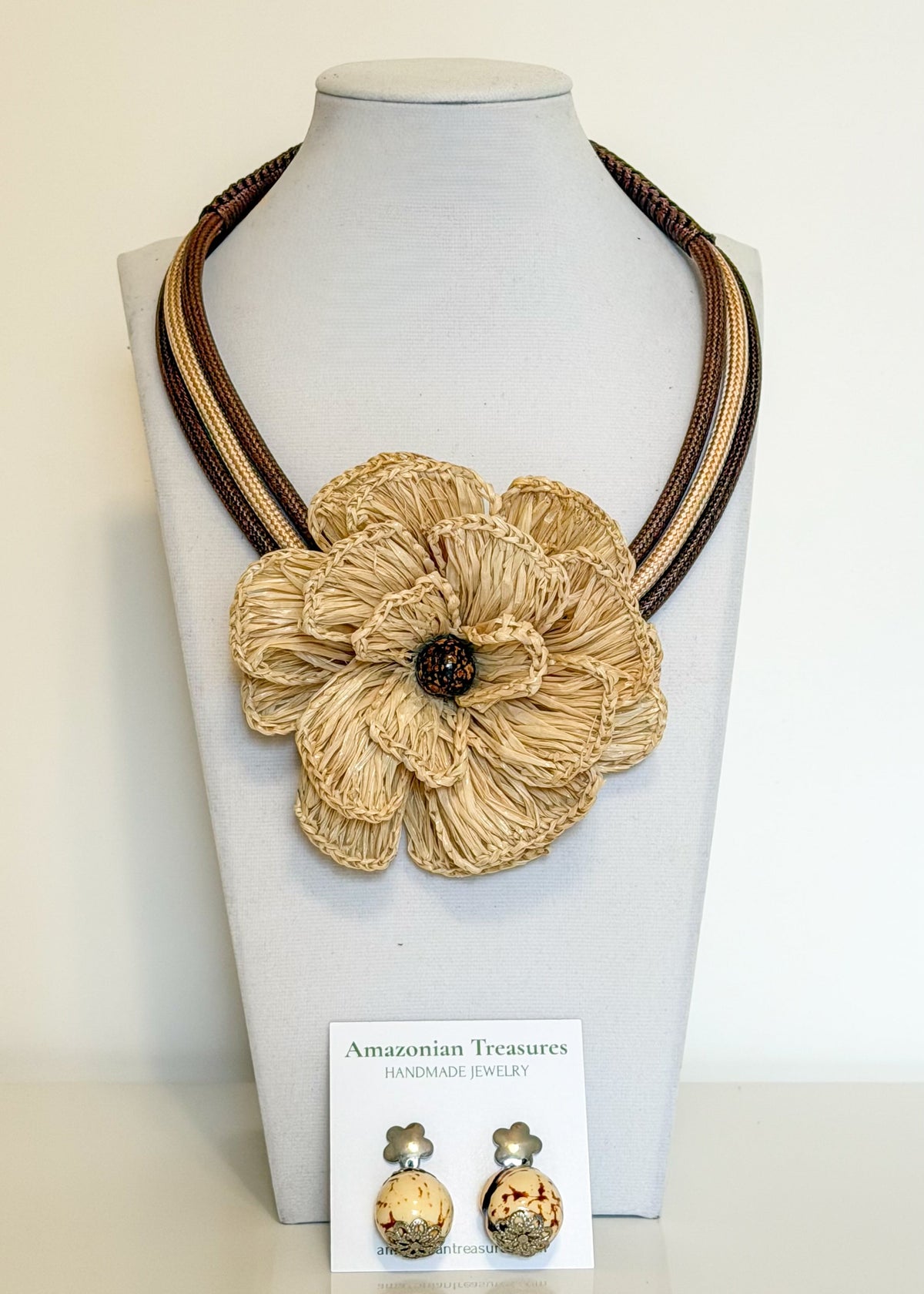 Amazonian Treasures handcrafted Buriti fiber flower statement necklace with matching Paxiúba seed earrings on display