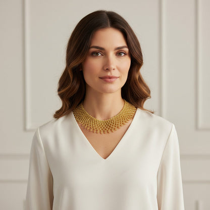 Amazonian Treasures Borari Indigenous gold glass bead collar necklace with delicate fringe worn by a woman