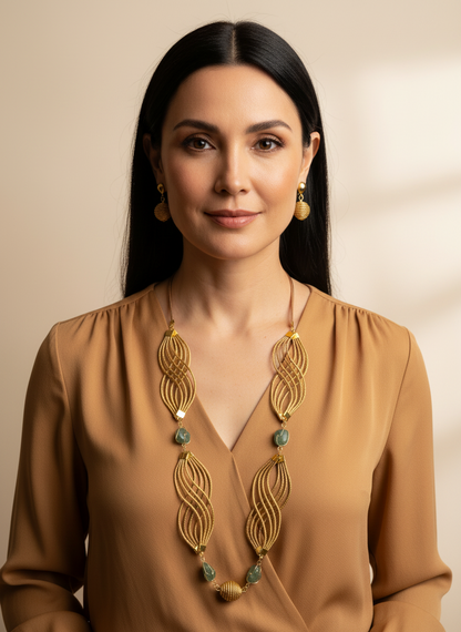 Amazonian Treasures Golden Flow necklace and earrings set made of woven capim dourado golden grass with green gemstones.