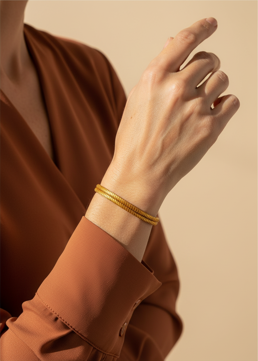 Amazonian Treasures handwoven golden grass bracelet worn on a wrist against a neutral background