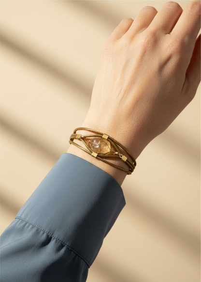 Amazonian Treasures handwoven capim dourado golden grass bracelet with a central citrine stone on a woman's wrist.