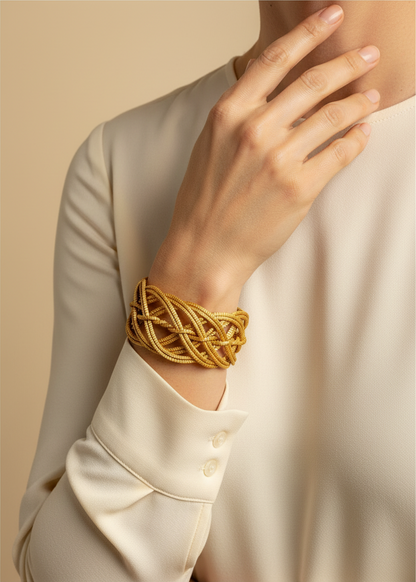 Amazonian Treasures handwoven golden grass statement cuff bracelet worn on a model's wrist against a neutral background